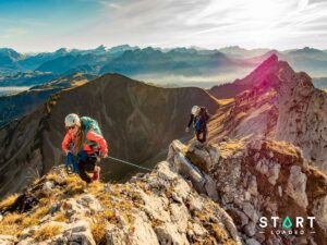Two hikers walking along a high mountain ridge