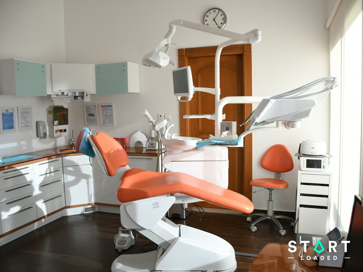 Orange dental chair in a bright dental clinic